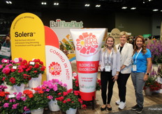 Lauren Blume, Maria Bolinger and Stephanie Vincenti of Ball FloraPlant, next to their line of Solera geraniums