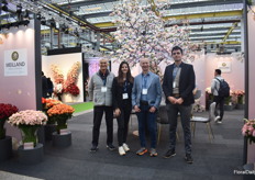 The team of Meilland in front of the tree with Alina perfumella, a rose variety named after the florist, who also decorated their booth.