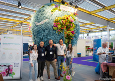 The Heemskerk Flowers/EZ Flower teams in their shared booth with a globe of flowers and fresh stroopwafels. (EZ Flower also provided the flowers in our booth!)